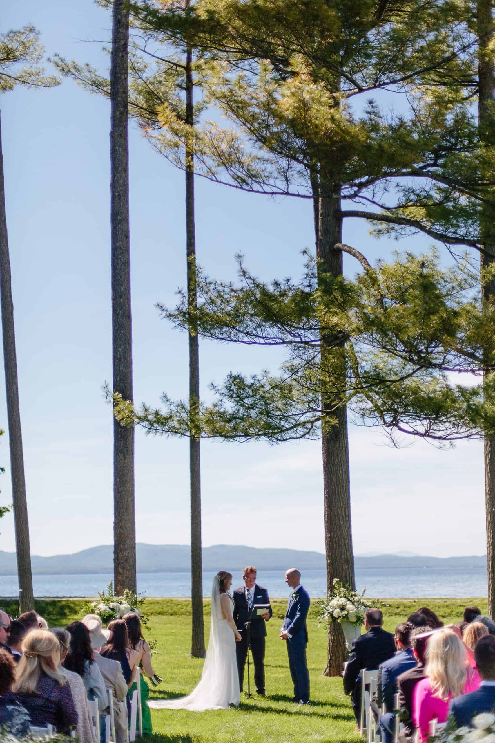 Ceremony under the pines at the Coach Barn Shelburne Farms wedding | Vermont Wedding Photographers - The Light + Color Wedding Photography
