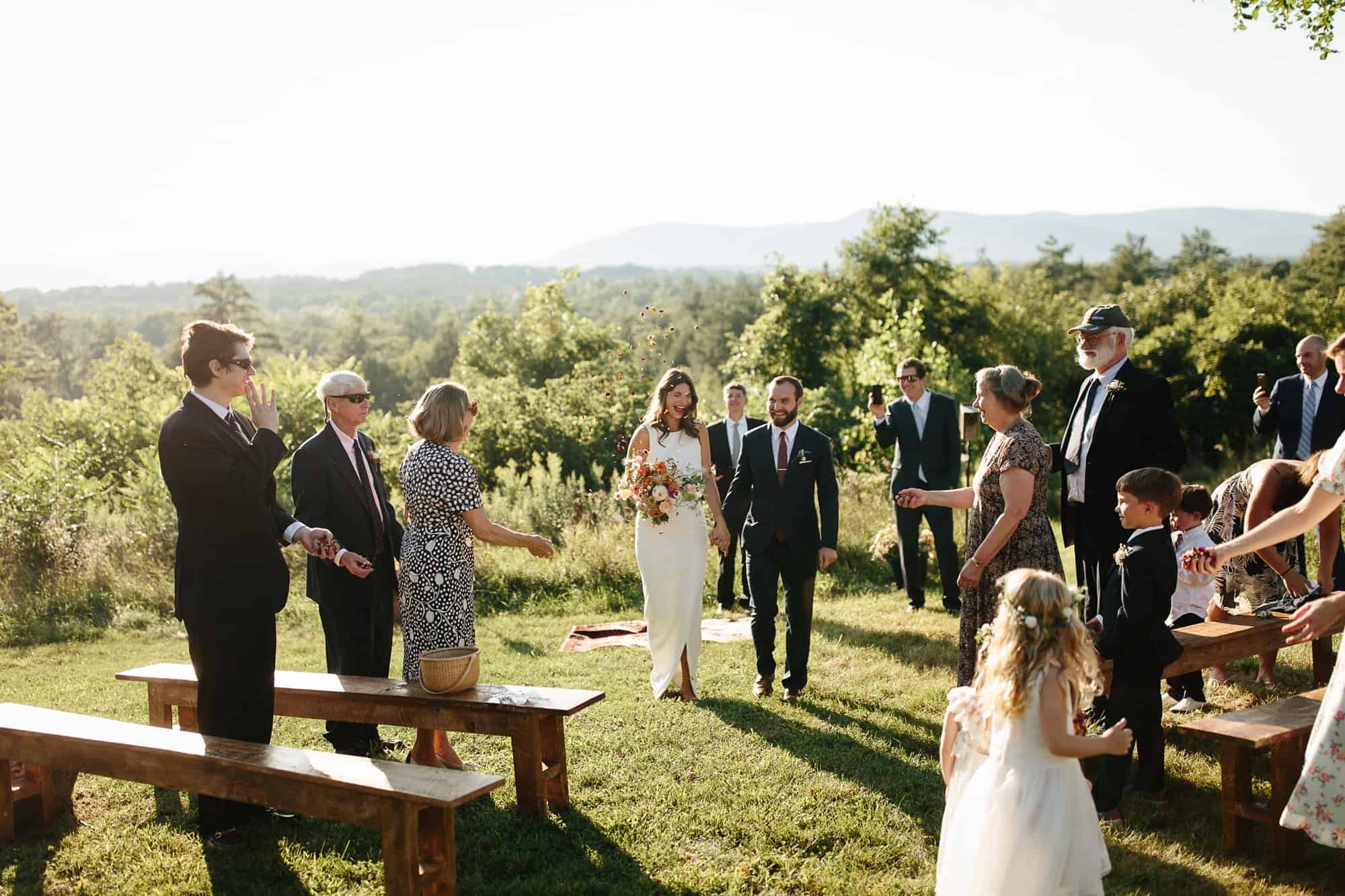 adirondack wedding photographers - bride and groom walking back up the aisle after ceremony
