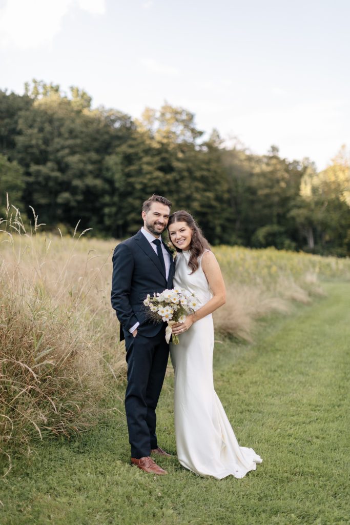 Couple in field at M & D Farm Wedding