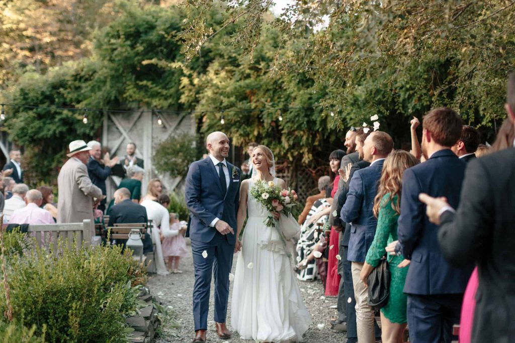 Couple walks back up aisle at M&D Farm wedding
