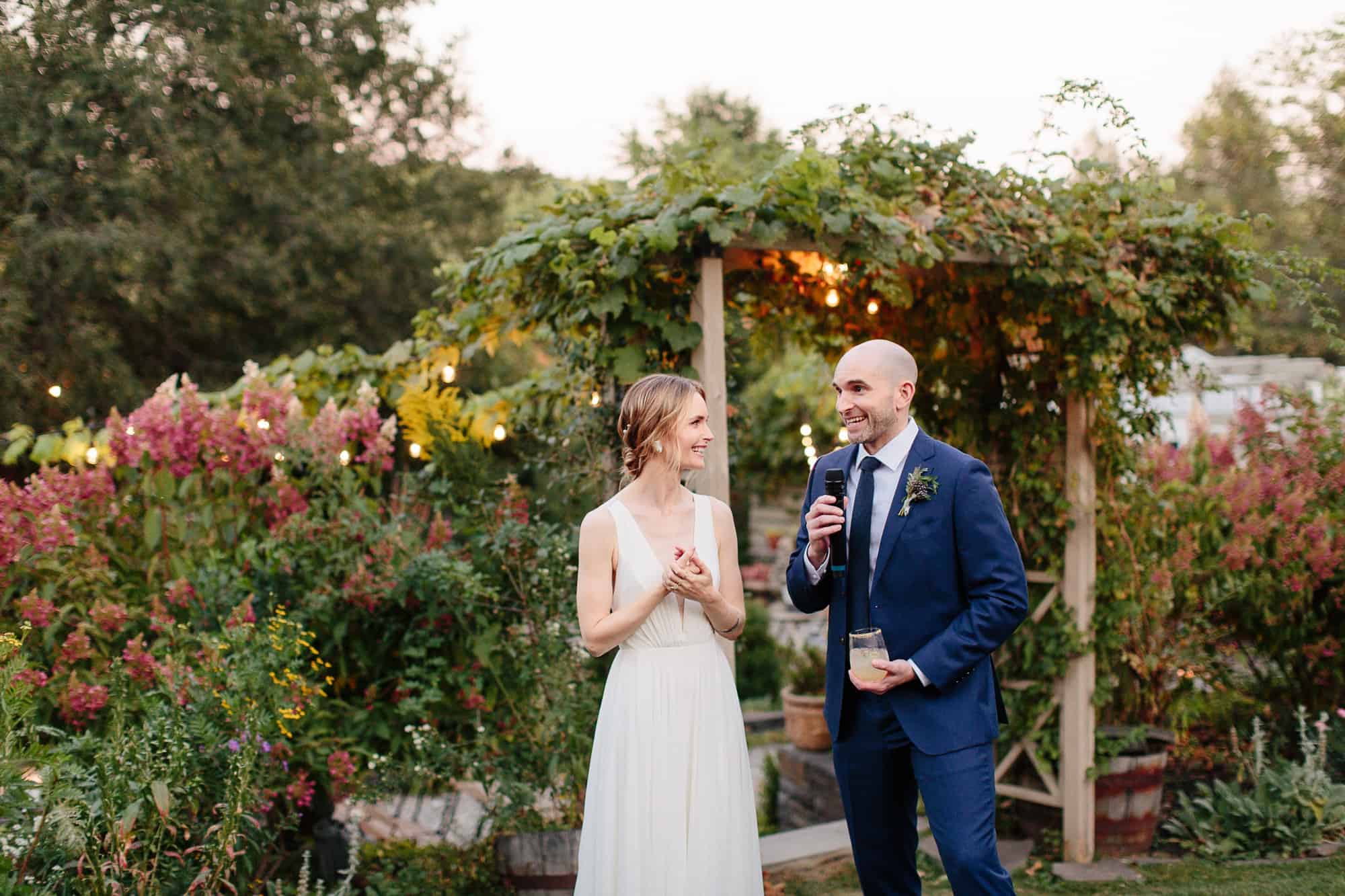 Bride and groom toast guests at their M&D farm wedding in the Catskills capture by upstate new york wedding photographers The Light and Color