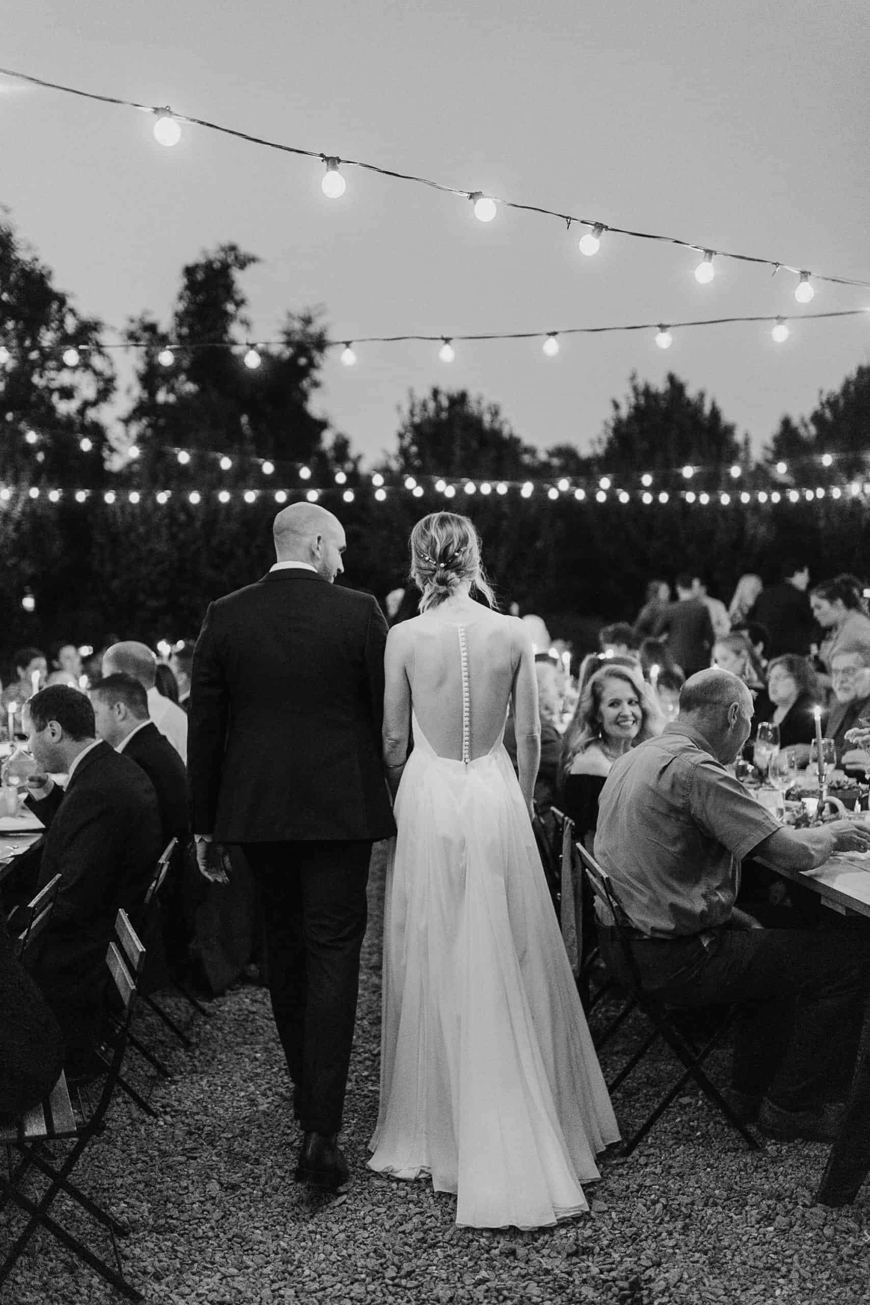 Bride and Groom and Guests enjoying an al fresco dinner at M&D farm wedding capture by Catskills wedding photographers The Light and Color