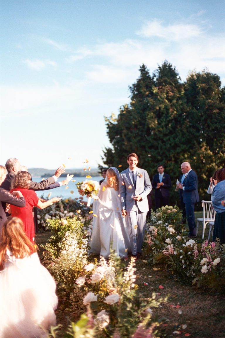 Bride and Groom recess up aisle at their Grand Isle Lake House wedding