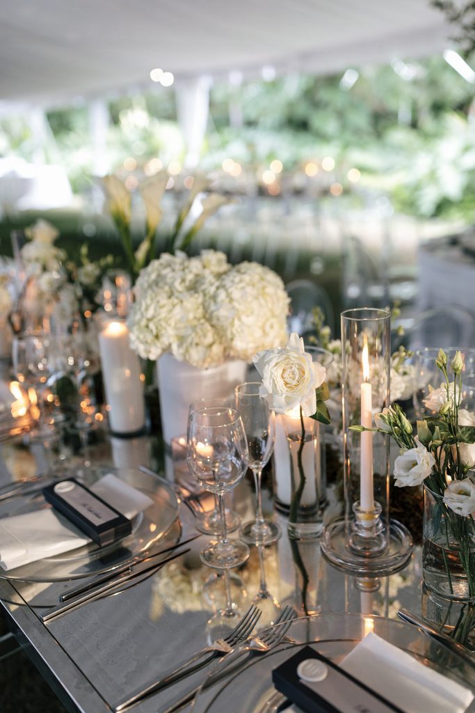 Green and white flowers on mirrored table at Norton art museum wedding