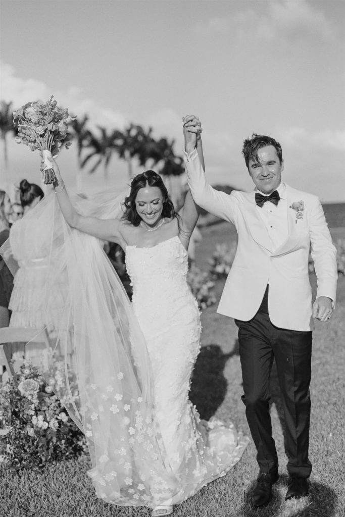 Bride and groom recessing from ceremony at Deering estate wedding