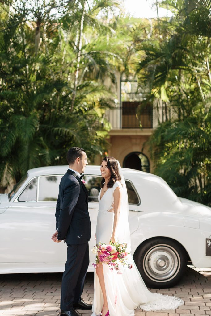 Bride and groom with vintage car in front of Villa Woodbine