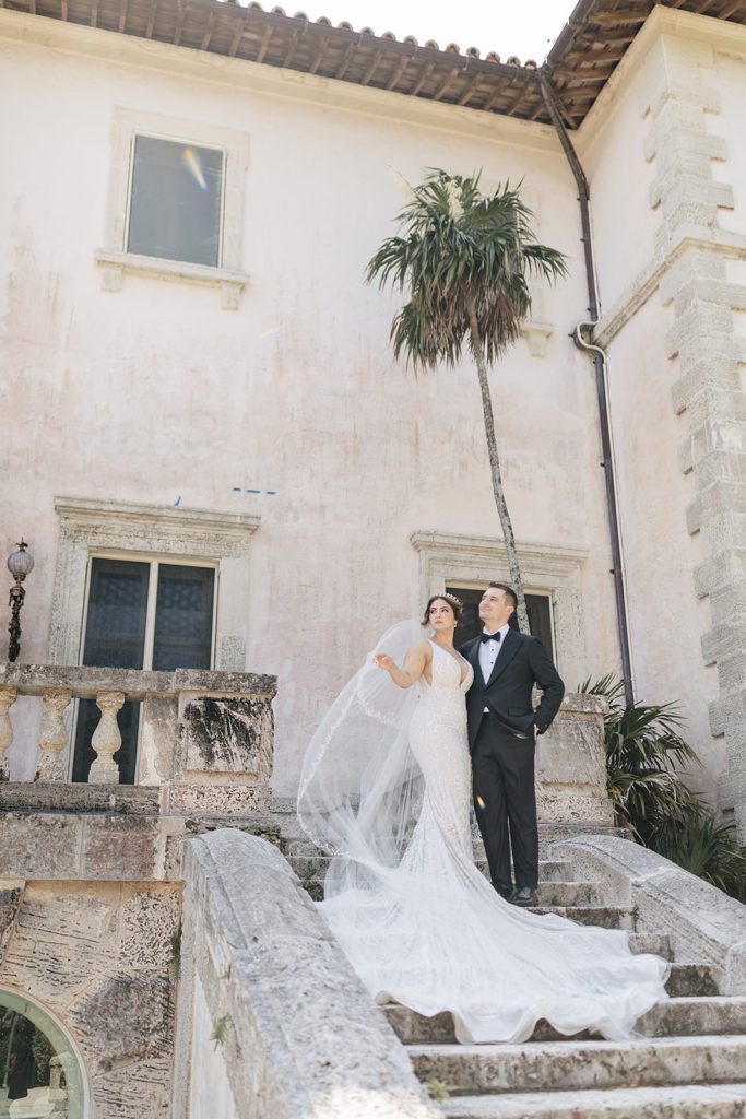 Bride and groom pose on stairs at Vizcaya wedding