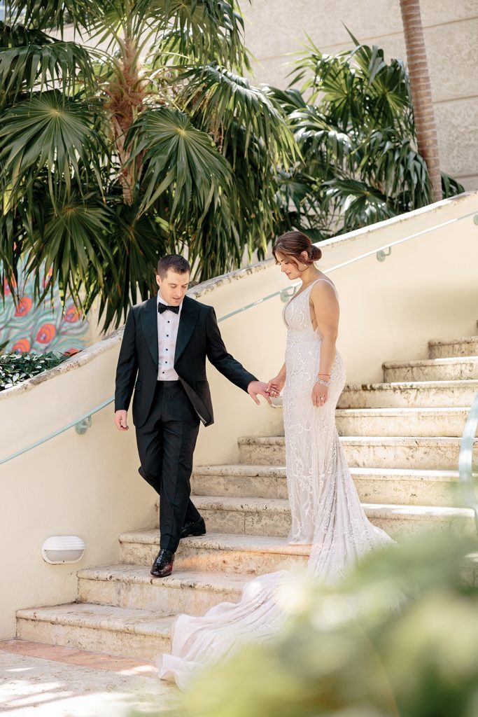 Bride and groom walk down stairs at Vizcaya wedding